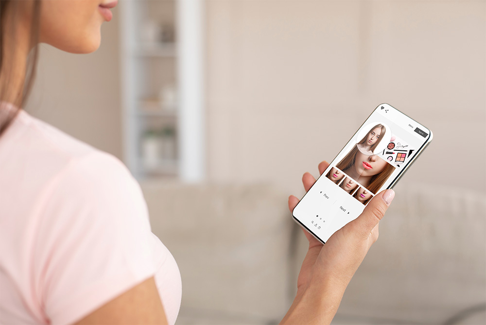 Woman holding phone with virtual beauty try-ons