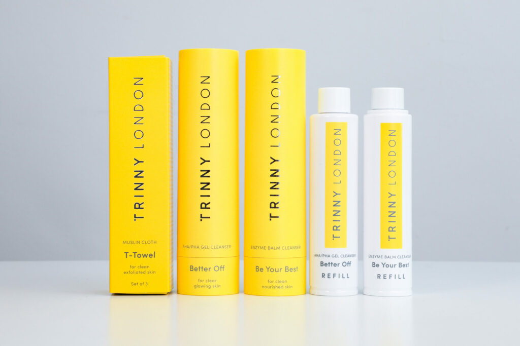 An assortment of beauty products in yellow and white tubes