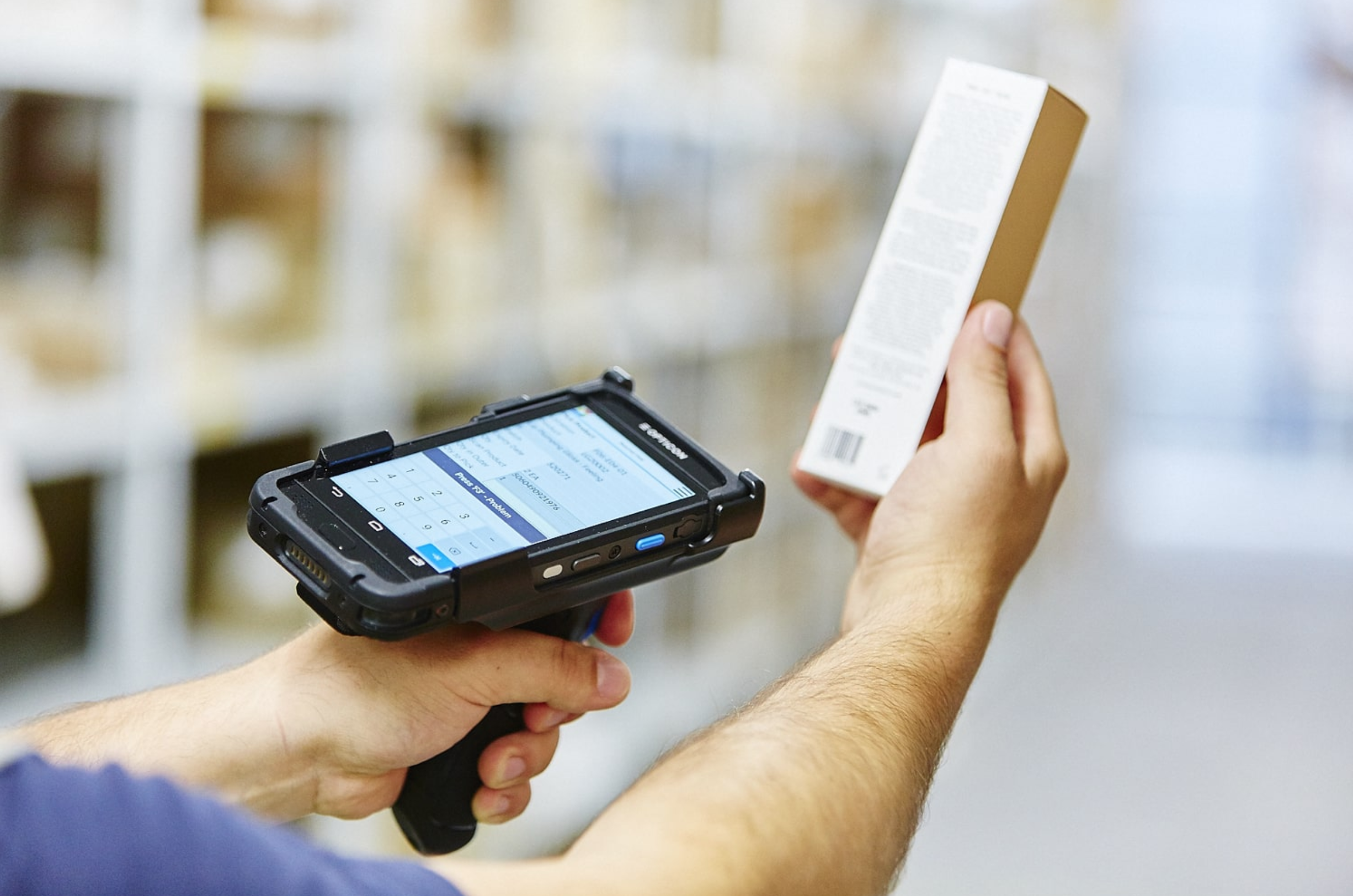 Person scanning a barcode of a white rectangular box